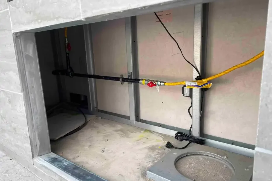 Under-slab rough-in opening in a garage with yellow gas line run overhead