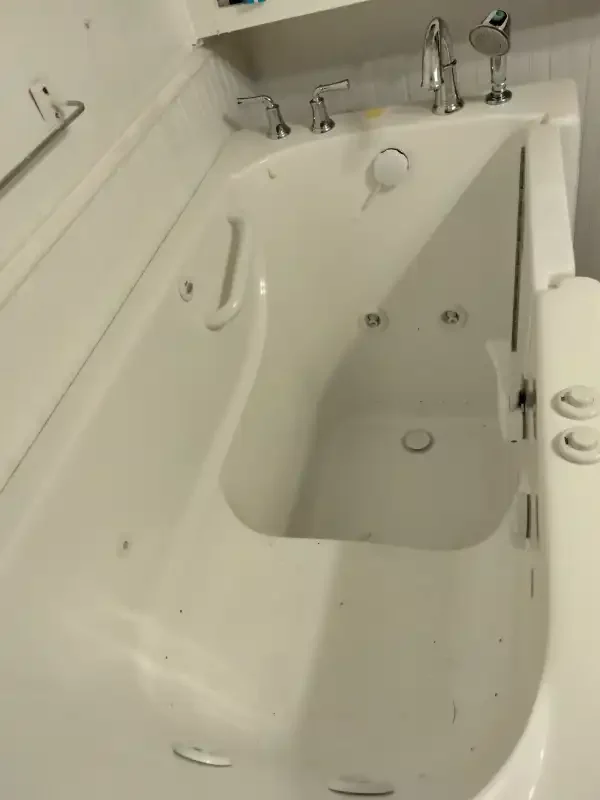 Walk-in tub with a side door and grab bar installed