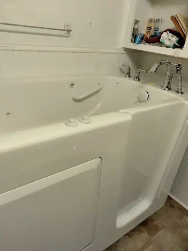 Walk-in tub with hand rails and integrated seat