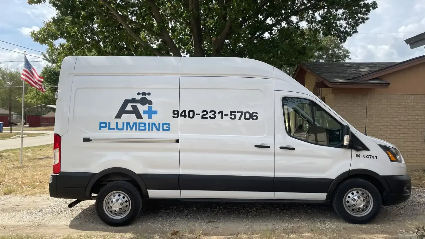 A+ Plumbing branded Transit van parked at a job