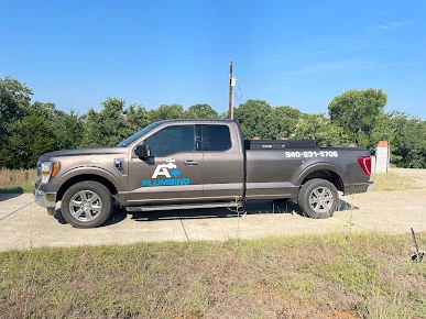 A+ Plumbing branded pickup truck parked roadside