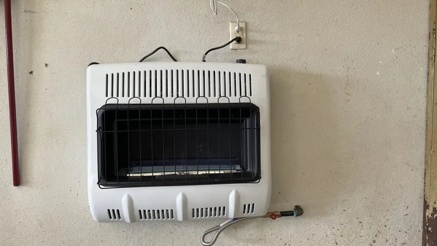 Vented gas wall heater installed on a painted wall