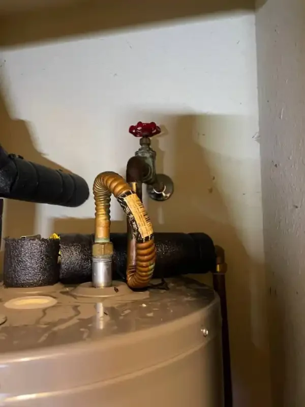 Yellow gas flex connector and shutoff valve at a heater