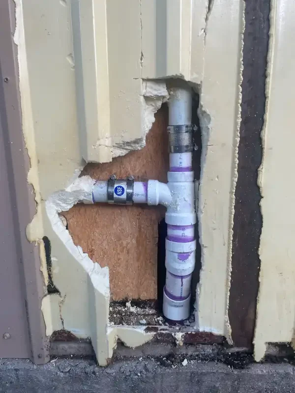 Repaired supply lines exposed in an opened interior wall