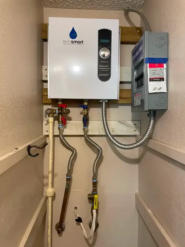 Wall-mounted tankless water heater with copper lines and disconnect