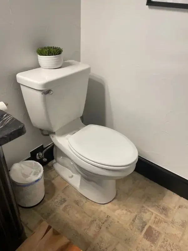 Newly installed toilet in a finished bathroom