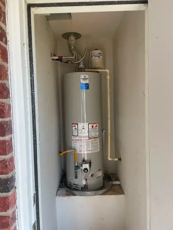 Gas water heater in an exterior brick closet
