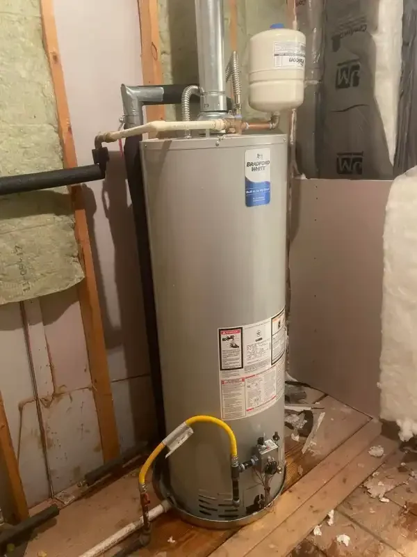 Tank water heater mid-replacement with the expansion tank above