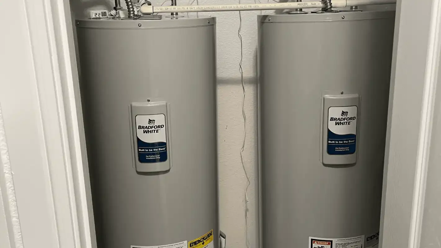Two tank water heaters installed side by side