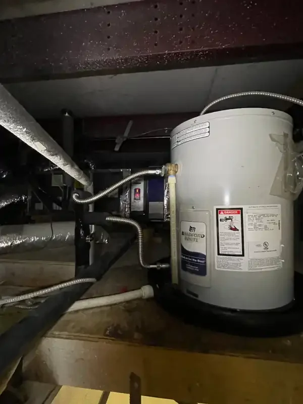 Water heater installed in a crawl space with supply lines