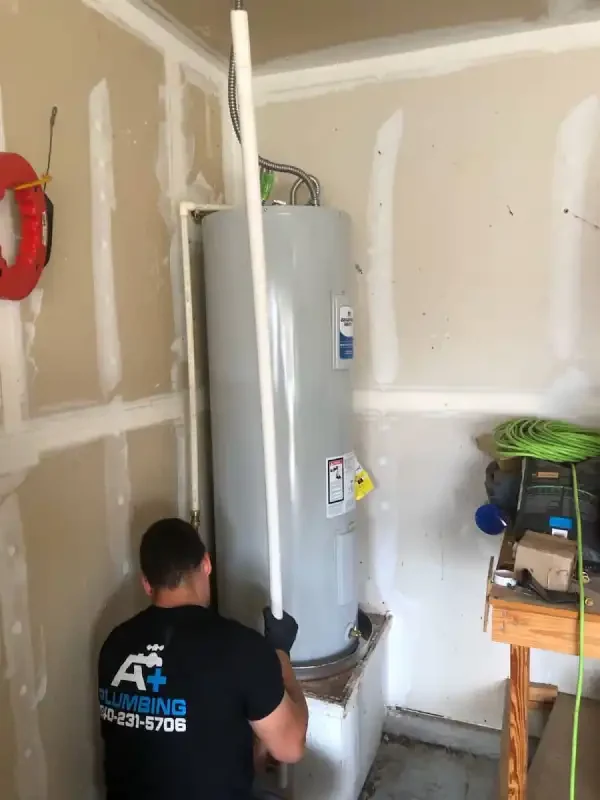 A+ Plumbing tech working on a water heater install